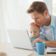 Man at desk with baby and computer Photo Credit: Tom Merton / Getty Images Israel